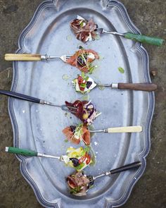 a platter filled with different types of appetizers on top of each other