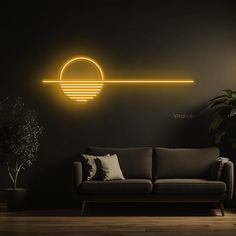 a couch sitting in front of a wall with a neon light