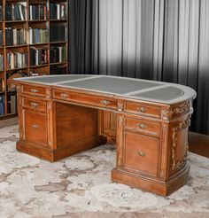 a large wooden desk sitting in front of a bookshelf