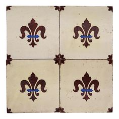 four brown and white fleur de lis tiles