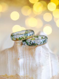 Dive into the beauty of the ocean with our unique resin ring, perfect for sea lovers. Each piece is handcrafted, delicately encapsulating the essence of the beach in a clear light blue tone. Authentic beach sand and tiny moss pieces mimic floating seaweed in crystal-clear waters, while shiny metal embellishments shaped like shells, conchs, and starfish add a touch of elegance and fantasy. This resin ring is perfect for stacking! It's smooth all the way around and it is so comfortable to wear.  A Ocean-inspired Promise Ring, Handmade Ocean-inspired Rings, Handmade Ocean-inspired Resin Jewelry, Moss Ring, Tiny Shells, Ocean Ring, Starfish Jewelry, Metal Embellishments, Promise Ring For Her