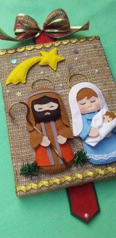 a christmas ornament with a nativity scene on it's front and sides