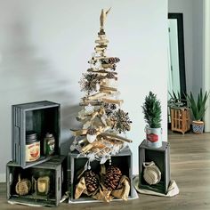 a christmas tree made out of wooden planks and pine cones in a living room