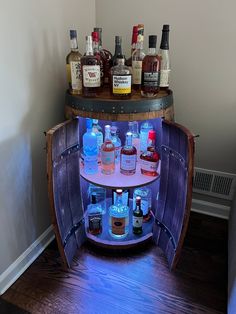 an open barrel with liquor bottles in it