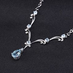 Extravagant sky blue topaz gemstone necklace with beautifully intricate and lavish flourish design. Chain necklace and pendant are made of 925 sterling silver. Details Item Type: Fine Jewelry Necklaces Metal Type: Sterling Silver Main Stone: Sky Blue Topaz Accessory Stone: Sky Blue Topaz Chain Length: 45cm Sky Blue Topaz: 5-1/3 ct. t.w. Cut: Pear,Round Affordable Blue Crystal Necklace For Gifts, Luxury Ethereal Jewelry For Promise, Luxury Handmade Light Blue Jewelry, Luxury Blue Bridal Necklace For Wedding, Luxury Light Blue Wedding Jewelry, Cheap Blue Engagement Jewelry, Luxury White Topaz Necklaces For Formal Occasions, Luxury Silver Mystical Necklace, Luxury Hand-set Blue Necklace