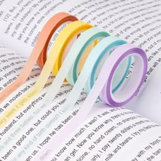 five different colored washi tapes on top of an open book