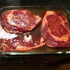 two raw meats in a pan ready to be cooked