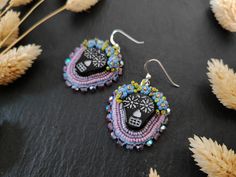 a pair of earrings sitting on top of a table