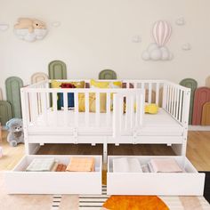 a baby's room with two cribs and toys on the floor