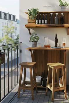 two wooden stools sitting on top of a balcony next to a bar filled with bottles and glasses