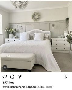 a bedroom with white furniture and decor on the walls