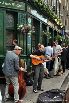 a group of people playing music on the street