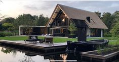 a house sitting on top of a lake next to a dock