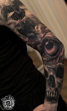 a man with a skull and bird tattoo on his arm