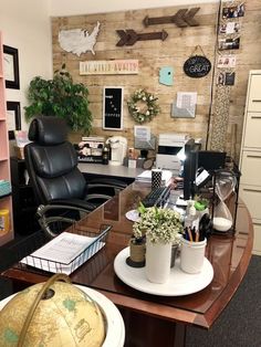 an office with a desk, chair, and map on the wall next to it