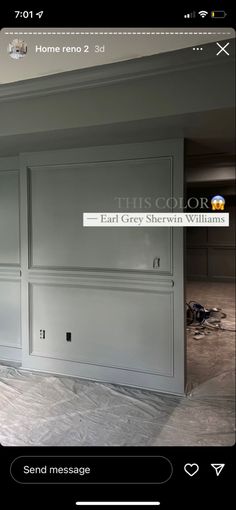 an empty room with gray cabinets and white walls