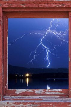 a window that has lightning in the sky