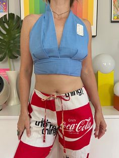 "Deadstock 1970s light blue chambray halter top Lined bodice Ties in back Cotton blend Est to fit an A - B cup best but go by measurements below for best fit. Buyer is responsible for confirming fit and sales are final. Please reach out with any questions!  CONDITION: new w/ tags - has been in storage since the 70s so may have a light mark or two MEASUREMENTS (taken laying flat then doubled where applicable:) 16-17\" long  up to 31\" underbust 13\" under cups only 8\" cup width  Model is 34B wit Fitted Light Wash Cotton Tank Top, Chic Cotton Halter Neck Top, Fitted Light Wash Tank Top For Spring, Chic Cotton Halter Top For Spring, Light Blue Fitted Summer Tops, Light Wash Cropped Tops For Spring, Trendy Cotton Halter Top For Day Out, Light Wash Sleeveless Cotton Crop Top, Retro Fitted Tank Top For Spring