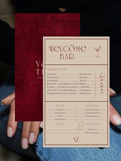 a woman's hand holding up a card with the words welcome bar on it