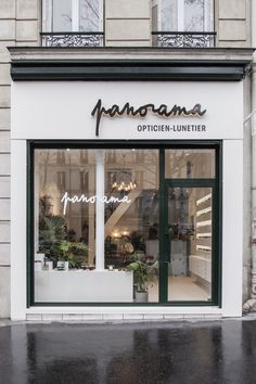 a store front with plants in the window