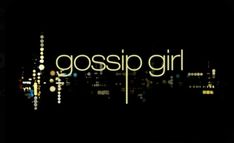 the words gossip girl are lit up in front of a cityscape at night