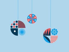 three colorful balls hanging from strings on a blue background