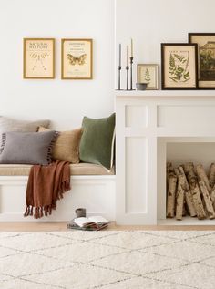 a living room filled with furniture and pictures on the wall next to a fire place