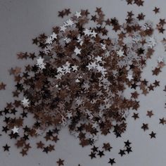 a bunch of star shaped confetti sitting on top of a table