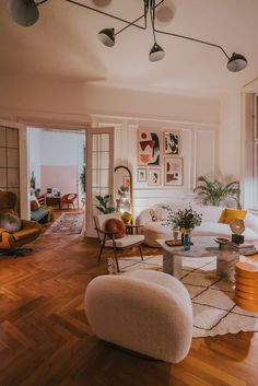 a living room filled with furniture and lots of windows