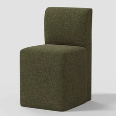 a green chair sitting on top of a white floor