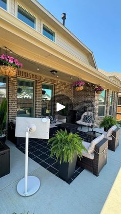 an outdoor living area with furniture and potted plants