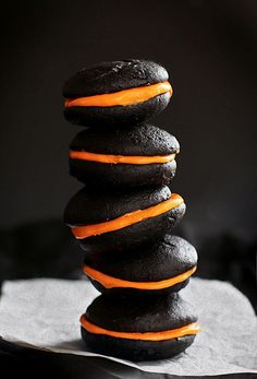 a stack of black and orange cookies sitting on top of each other