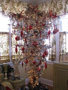 a decorated christmas tree in the corner of a room