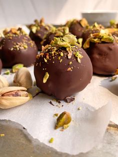 several chocolate balls with nuts and pistachios on top