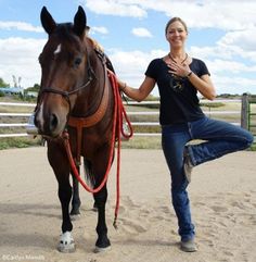 a woman standing next to a brown horse