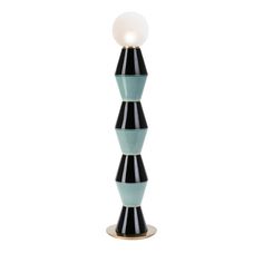 a tall black and blue lamp with a white light on it's top, against a white background