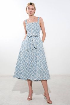 A textured denim midi dress featuring straight neckline, straps, self sash, button down detail, full skirt and back zipper closure Details: Self : 65% Cotton 35% Polyester Size & Fit - Model is 5`9" And Wearing Size Small- Measurements Taken From Size Small- Approx. Length: 41.5" Chic Cotton Denim Midi Dress, Casual Midi Dress With Tie Fastening, Square Neck Cotton Midi Dress For Day Out, Midi Dress With Tie Fastening For Day Out, Knee-length Midi Dress With Tie Straps For Day Out, Belted Blue Denim Summer Dress, Spring Midi Dress With Tie Fastening, Day Out Midi Dress With Tie Fastening, Cotton Denim Midi Dress For Casual Wear