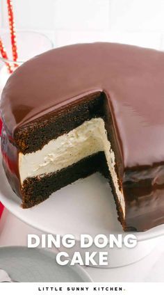 there is a chocolate cake with white frosting on the top and one slice missing