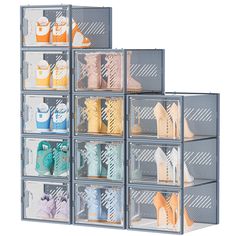 four clear bins filled with different types of shoes and other items on display against a white background