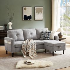 a living room with a gray couch and white rug