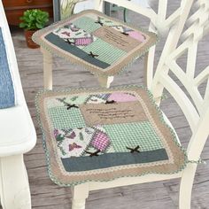 two white chairs sitting on top of a wooden floor