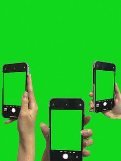 three people holding up their cell phones with green screen