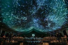 the ceiling is covered with stars and lights as it shines in the night sky