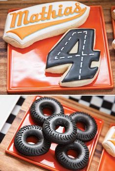 cookies and cookies decorated with the number four are on display in front of an orange plate