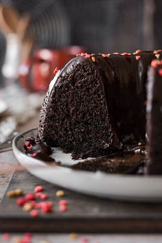 a slice of chocolate cake on a plate with sprinkles