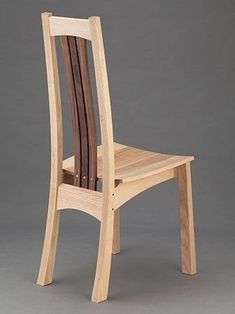 a wooden chair sitting on top of a gray floor