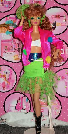 a barbie doll dressed in a green skirt and pink jacket with polka dots on the wall