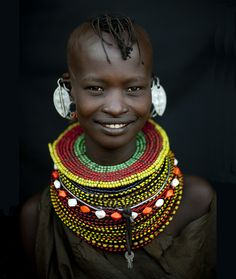 an african woman with many necklaces on her neck