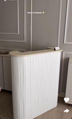 an image of a kitchen setting with white appliances and wood flooring on the walls