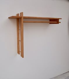 a wooden shelf mounted to the side of a wall